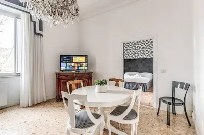 a dining room with a white table and chairs at Lovely renovated flat by Vatican in Rome