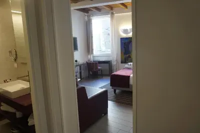 a room with a bedroom with a bed and a window at Trevi Palace Luxury Inn in Rome