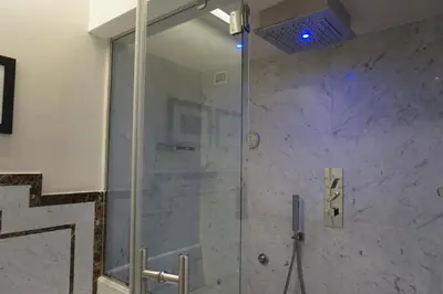 a shower with a glass door in a bathroom at Trevi Palace Luxury Inn in Rome