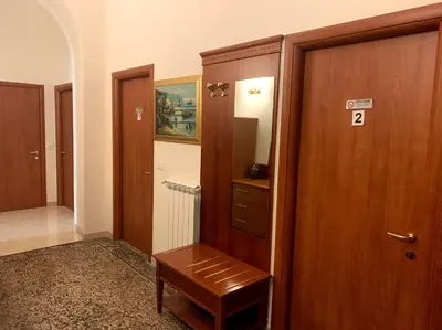 a hallway with a wooden door and a wooden stool at Paramount in Rome