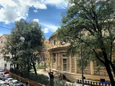a building on a street with cars parked in front of it at Paramount in Rome