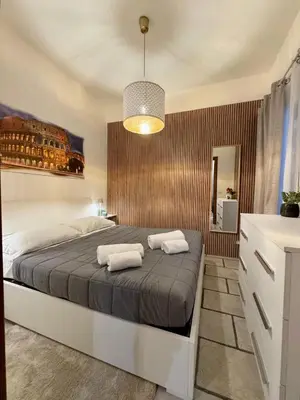 a bedroom with a bed with two towels on it at Leonina 75 Holidays in Rome