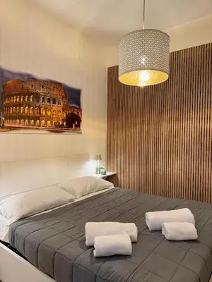 a bedroom with a large bed with two white pillows at Leonina 75 Holidays in Rome