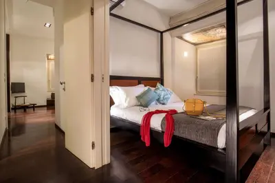 a bedroom with a bed with a red scarf on it at SK ROME Apartment Luxury Torre Argentina in Rome