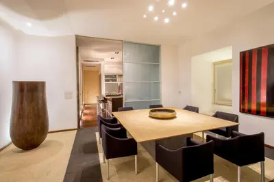 a dining room with a wooden table and chairs at SK ROME Apartment Luxury Torre Argentina in Rome