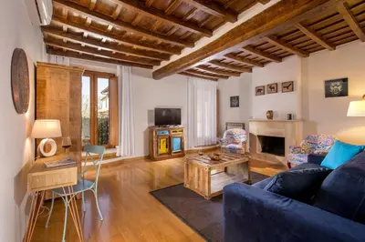 a living room with a blue couch and a fireplace at SK ROME - Apartment Luxury Navona in Rome