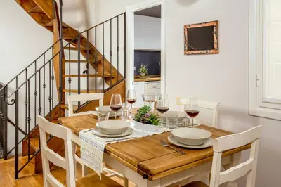 a dining room with a wooden table with wine glasses at SK ROME - Apartment Luxury Navona in Rome