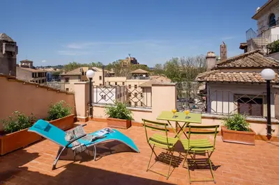 a patio with a table and chairs on a roof at SK ROME - Apartment Luxury Navona in Rome