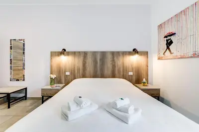 a bedroom with a large white bed with two towels at B&B Casa Der Poeta in Rome