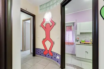 a room with a wall with a drawing of a person standing on a diving board at B&B Casa Der Poeta in Rome