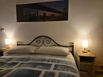 a bedroom with a bed with two tables and two lamps at A casa di Alex Vatican in Rome