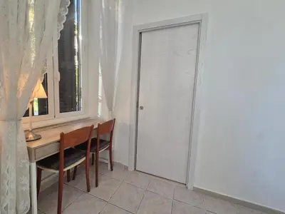 a door in a room with a desk and a window at A casa di Alex Vatican in Rome