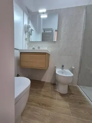 a bathroom with a sink and a toilet and a mirror at A casa di Alex Vatican in Rome