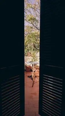 a view from a door of a patio with a table at Casa ParticulART in Rome