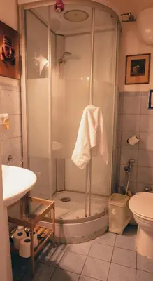 a bathroom with a shower with a sink and a toilet at Casa ParticulART in Rome