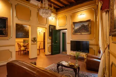 a living room with a couch and a tv at Antica dimora navona in Rome
