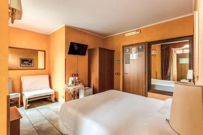 a bedroom with a bed and a chair in it at Guest House Masterintrastevere in Rome