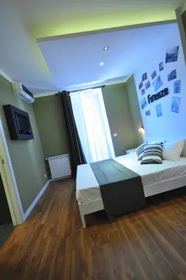 a bedroom with a large bed with a large window at B&B Destinazione Roma in Rome