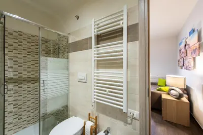 a bathroom with a toilet and a glass shower at Domus Caracalla Nel Cuore Di Roma in Rome