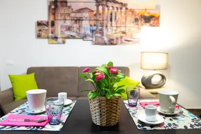 a table with a vase with a plant on it at Domus Caracalla Nel Cuore Di Roma in Rome