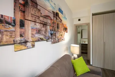 a living room with a couch and some paintings on the wall at Domus Caracalla Nel Cuore Di Roma in Rome