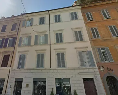 a large white building with shutters on it at Penna Flats in Rome