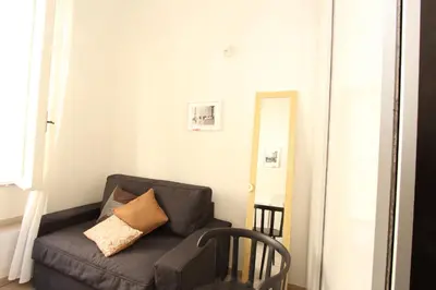 a living room with a couch and a mirror at Penna Flats in Rome