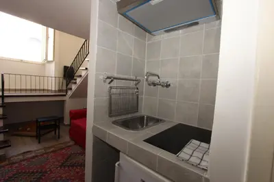 a bathroom with a sink and a staircase at Penna Flats in Rome