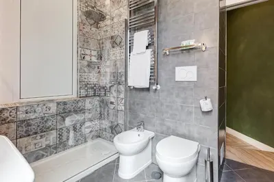 a bathroom with a toilet and a sink and a tub at Ripetta Natural Suites in Rome