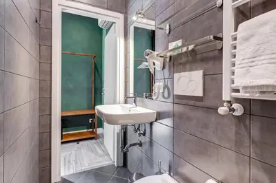 a bathroom with a sink and a toilet at Ripetta Natural Suites in Rome