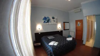 a bedroom with a bed with two towels on it at Casa Cleo in Rome
