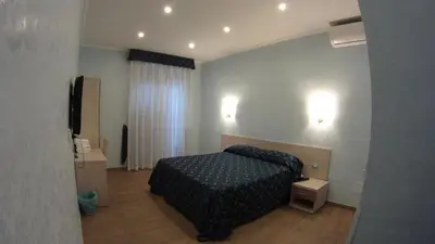 a bedroom with a bed and a television in it at Casa Cleo in Rome