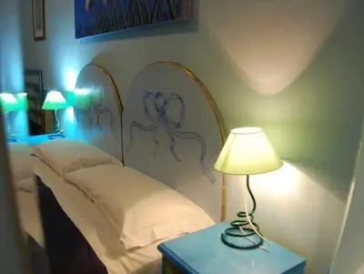 a bedroom with a bed and a table with a lamp at Casa Cleo in Rome