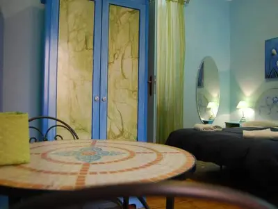 a room with a table and a room with a bed and a table at Casa Cleo in Rome