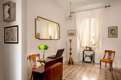 a room with a desk with a laptop and a mirror at Guesthouse Serafino in Rome