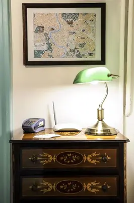 a desk with a lamp and a phone on it at Guesthouse Serafino in Rome