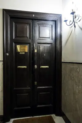 a pair of wooden doors in a room at Guesthouse Serafino in Rome