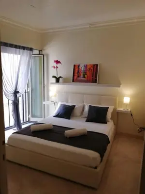 a bedroom with a large bed with a window at Navona Private Rooms bnb in Rome