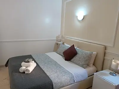a bedroom with a bed with towels on it at Navona Private Rooms bnb in Rome