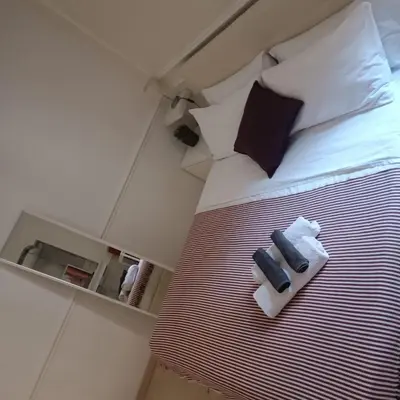 a bedroom with a bed with two towels on it at Navona Private Rooms bnb in Rome