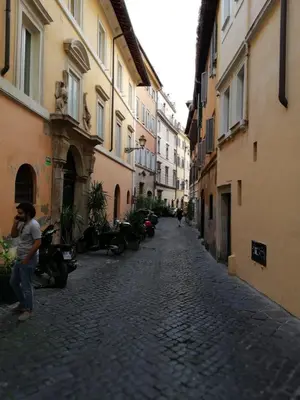 a woman standing in an alley between two buildings at Navona Private Rooms bnb in Rome