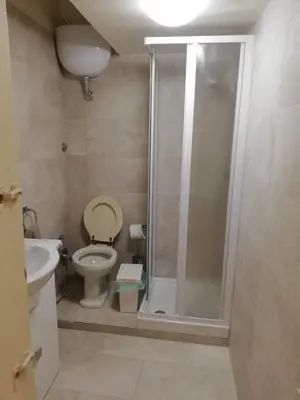 a bathroom with a shower with a toilet and a sink at Navona Private Rooms bnb in Rome