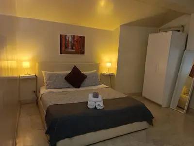 a bedroom with a bed with two controllers on it at Navona Private Rooms bnb in Rome
