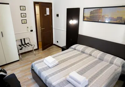 a bedroom with a bed with two towels on it at GH Colosseum in Rome