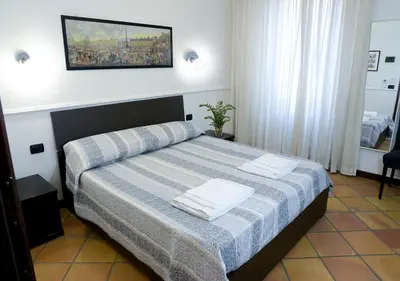 a bedroom with a bed with two towels on it at GH Colosseum in Rome