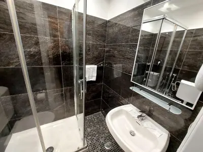 a bathroom with a shower and a sink at Hotel Positano in Rome