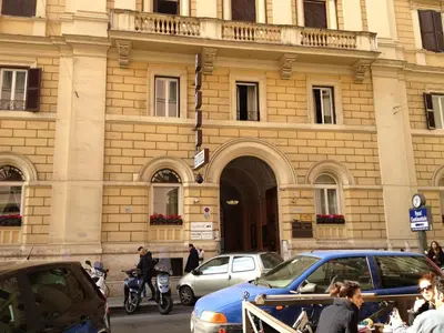 a building with cars parked in front of it at Hotel Positano in Rome