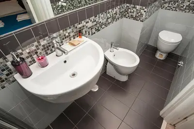 a bathroom with a sink and a toilet at Flowerome in Rome