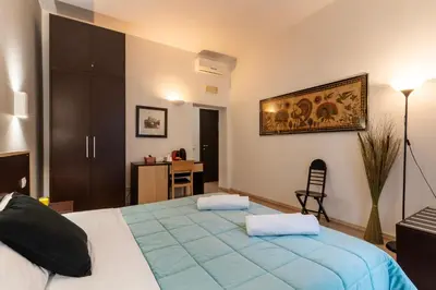 a bedroom with a large bed and a desk at Flowerome in Rome