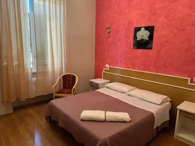 a bedroom with a bed with a towel on it at Trani B&T Rooms in Rome